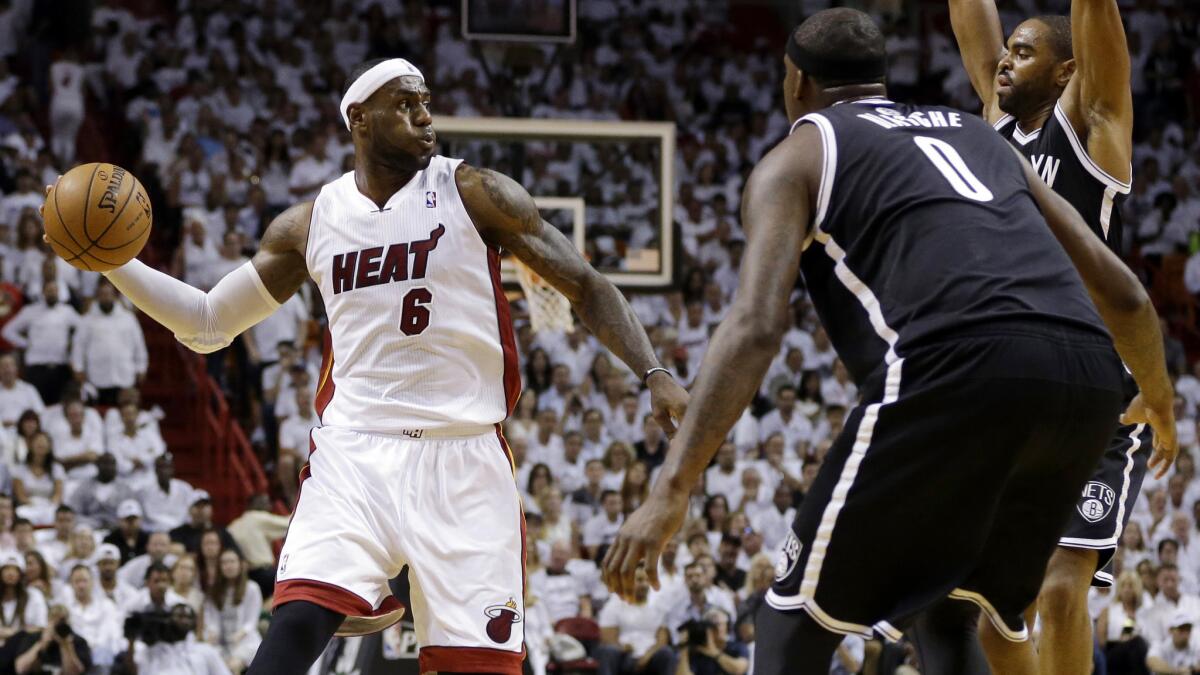 Miami's LeBron James looks to pass around Brooklyn Nets defender Andray Blatche during the Heat's 107-86 win over the Brooklyn Nets in Game 1 of the Eastern Conference semifinals Tuesday.