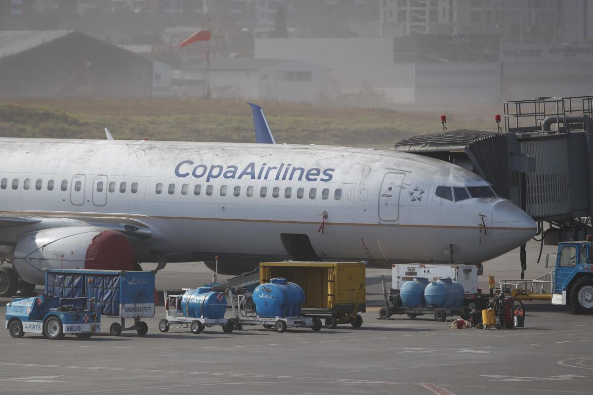A Copa Airlines plane is dusted in volcanic ash