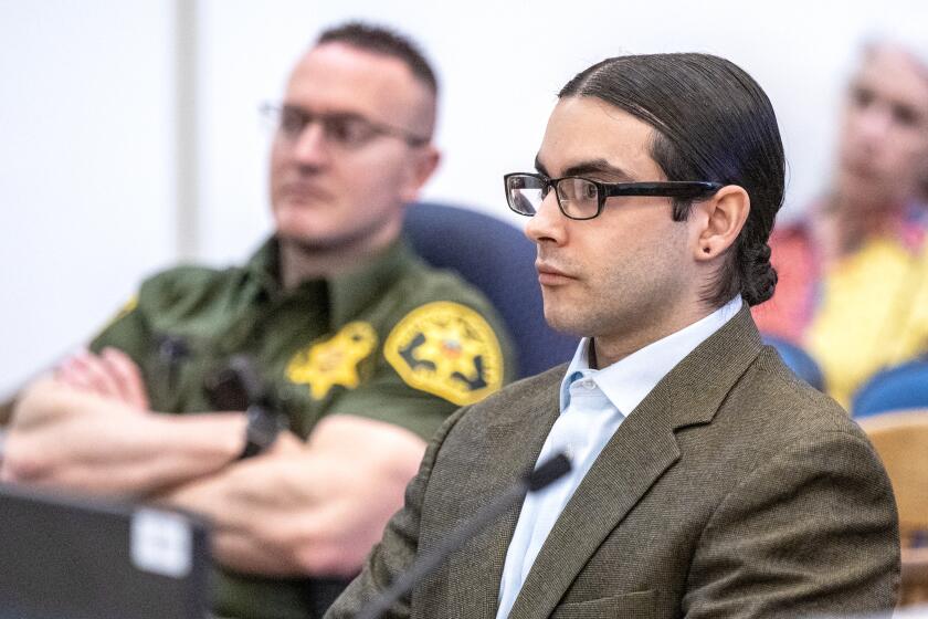 Marcus Eriz, right, the gunman who shot and killed 6-year-old Aiden Leos during a road rage confrontation on the 55 freeway in Orange in 2021, sits in Orange County Superior Court prior to Judge Richard M. King sentencing him to 40 years to life in state prison, in Santa Ana on Friday, April 12, 2024. (Mark Rightmire, Orange County Register/Pool)