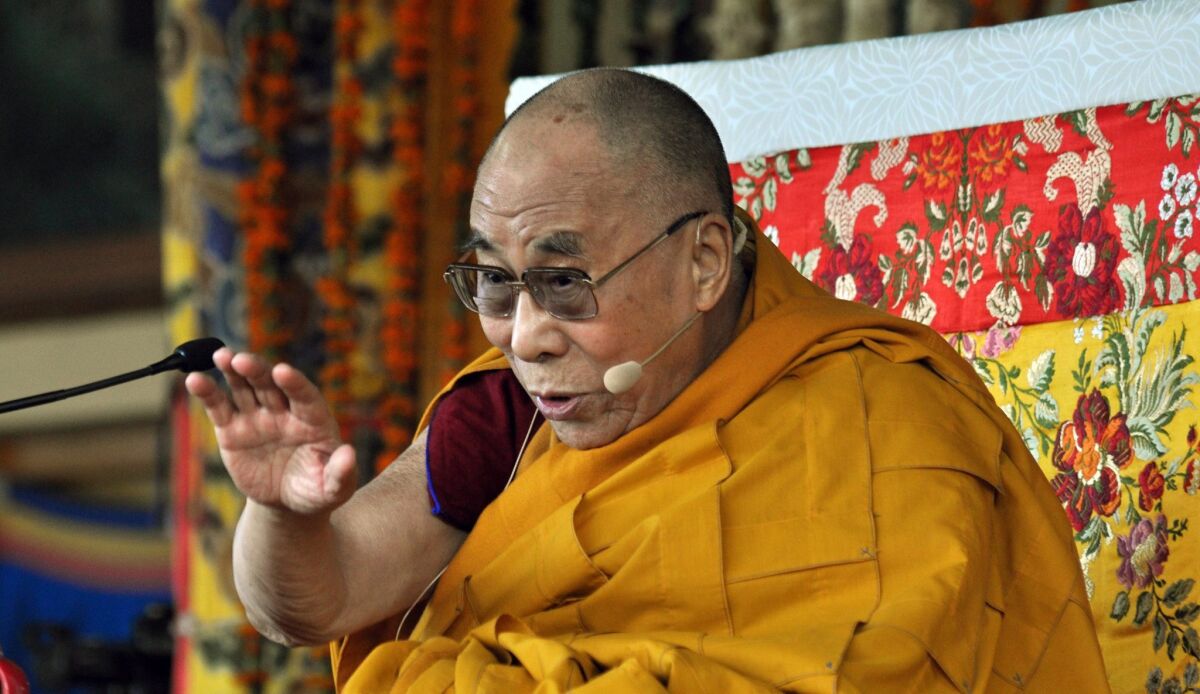 The Dalai Lama gestures as he speaks during a session of short teaching from the Jataka Tales at the main Tibetan Tsuglagkhang temple at McLeodGanj in India.
