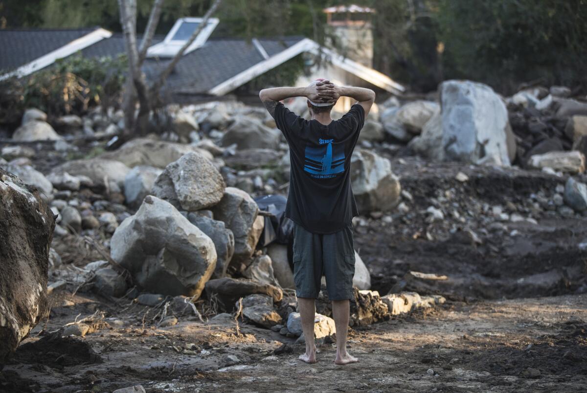 Travis Zehntner looks over the remains of destroyed homes on Glen Oaks Drive in Montecito on Jan. 11.