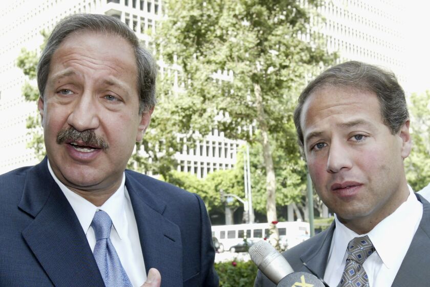 FILE - Attorneys Mark Geragos, left, and Brian Kabateck speak to the media outside the United States Federal Court building in Los Angeles, July 30, 2004, after a judge approved a multimillion-dollar settlement in a lawsuit for unpaid life insurance benefits filed by descendants of Armenians killed in the Turkish Ottoman Empire. The State Bar of California said Tuesday, Sept. 27, 2022, that it is investigating Geragos and Kabateck in connection with the spending of money in the United States and France from the settlement. (AP Photo/Nick Ut, File)