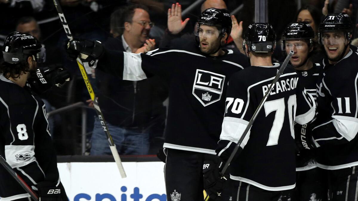 Kings center Tyler Toffoli (center) is congratulated by teammates after scoring against the Hurricans in the second period Saturday at Staples Center.