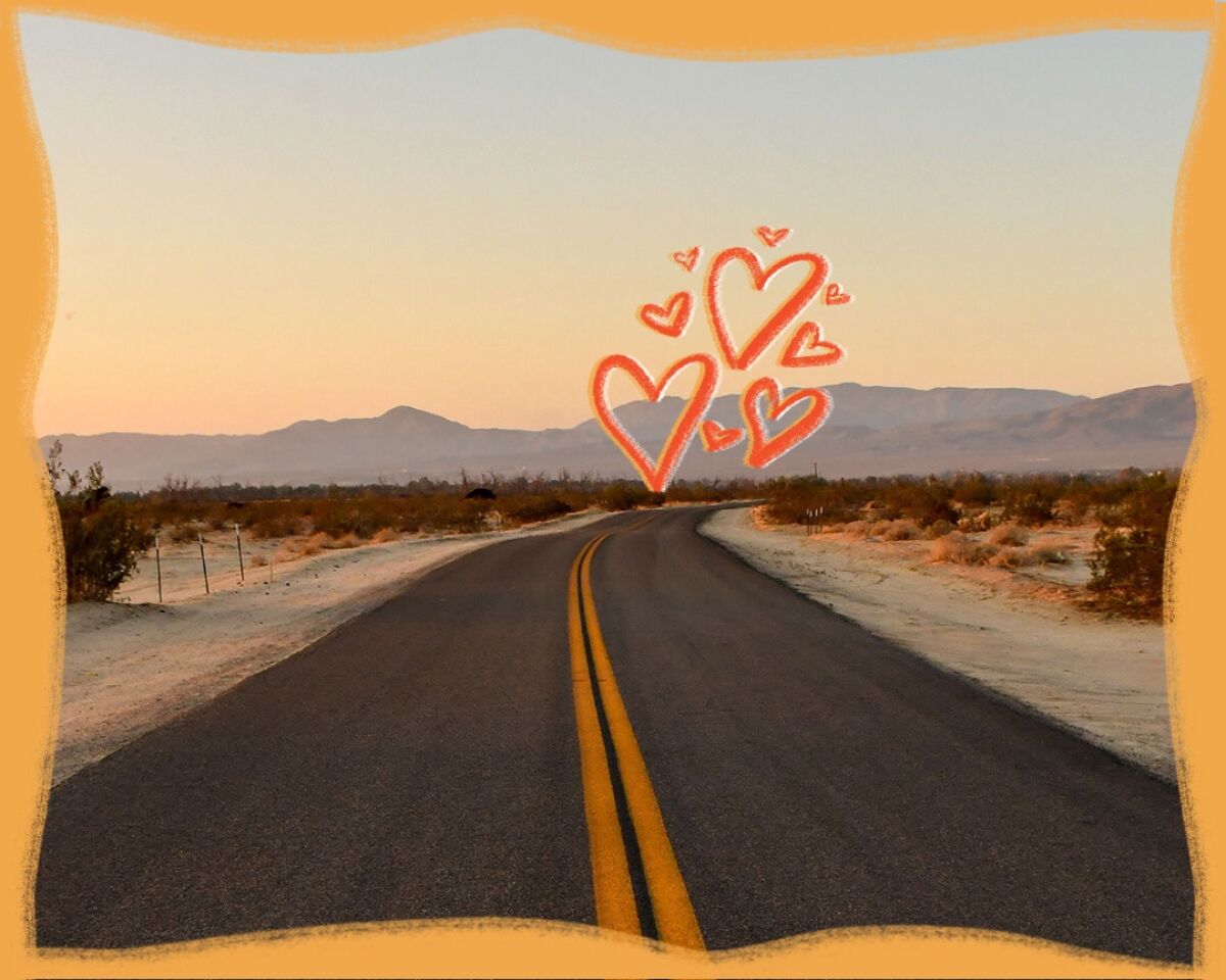 Hearts are drawn atop a photo of a two-lane highway. 
