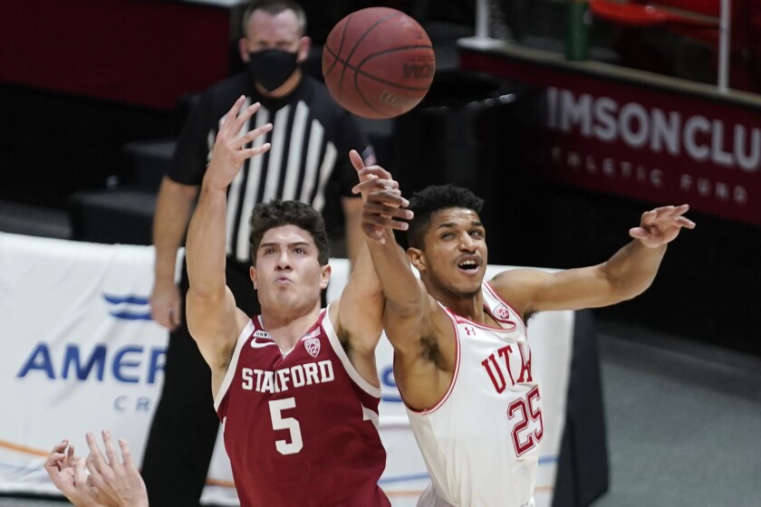 Utah guard Alfonso Plummer (25) and Stanford guard Michael O'Connell (5) battle for a rebound in the first half during an NCAA college basketball game Thursday, Jan. 14, 2021, in Salt Lake City. (AP Photo/Rick Bowmer)