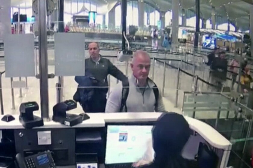FILE— This Dec. 30, 2019 image from security camera video shows Michael L. Taylor, center, and George-Antoine Zayek at passport control at Istanbul Airport in Turkey. Americans Michael Taylor and his son Peter Taylor go on trial in Tokyo on Monday, June 14, 2021, on suspicion they helped Nissan former Chairman Carlos Ghosn skip bail in Japan and escape to Lebanon in December 2019. (DHA via AP, File)