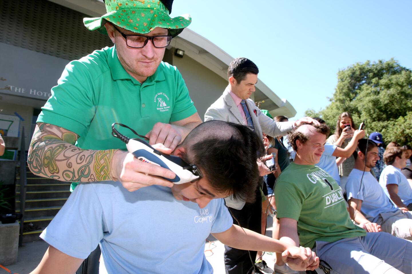 La Cañada High School student Ben Choi gets his head shaved by Bridge Program advisor Gavin Williams during fundraiser for the Baldrick's Foundation at the school in La Cañada Flintridge, on Thursday, March 17, 2016. About 20 students, a teacher and the principal participated in the fundraiser which aimed to raise about $10,000.