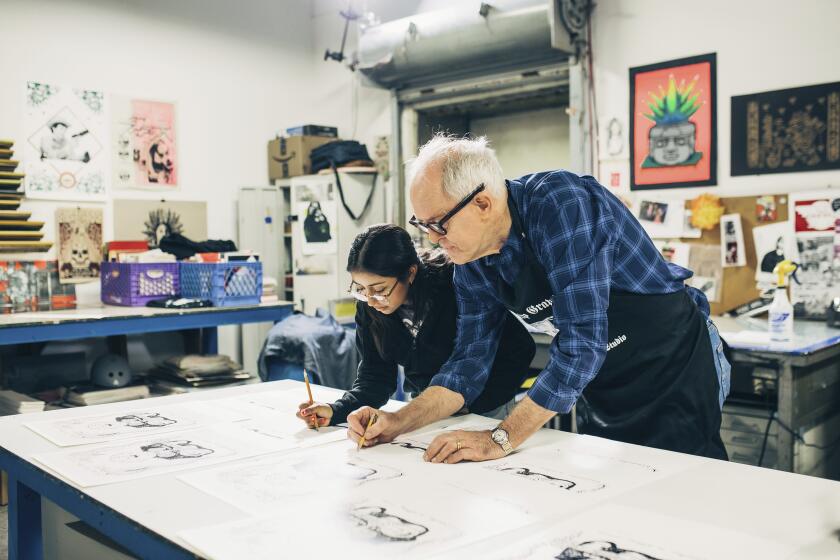 This image released by PBS shows actor John Lithgow, right, with Yoli, as they work on a screen print drawing during the filming of "Art Happens Here With John Lithgow," premiering April 26. (Antonio Diaz/PBS SoCal via AP)