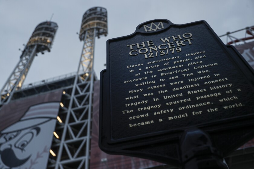 FILE - This Wednesday, Nov. 20, 2019, file photo shows a memorial plaque for the 11 concertgoers who were killed in a crush of people entering a 1979 concert by the British rock band The Who, outside Great American Ball Park in Cincinnati. Alumni of nearby Finneytown High School, who lost three classmates in the tragedy, faced obstacles in 2020 to their annual memorial scholarship fund-raising event. In the end, they created a show of prerecorded video interviews with The Who's frontman, Roger Daltrey, guitarist-songwriter Pete Townshend and a mix of recorded and live discussions with relatives of the 11 people killed in the tragedy. (AP Photo/John Minchillo, File)