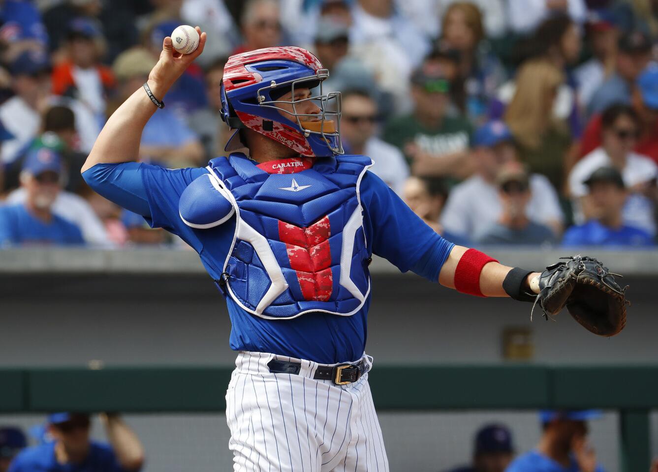 Cubs catcher Victor Caratini throws against the Arizona Diamondbacks during the third inning of a spring training baseball game Thursday, March 15, 2018, in Mesa, Ariz.