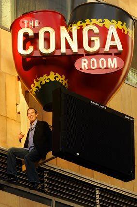 LOS ANGELES, CA. - DECEMBER 1, 2008: Brad Gluckstein, founder and co-owner of the new Conga Room in downtown Los Angeles, is photographed on the sign outrside (and overlooking the club) on Dec. 1. The Conga Room is reopening next to the Nokia Theatre across the street from Staples Center and is part of LA Live. The club used to be in the Miracle Mile area of Los Angeles and was known among Latin and world musician means as a key venue for hearing live music. (Gary Friedman/Los Angeles Times)