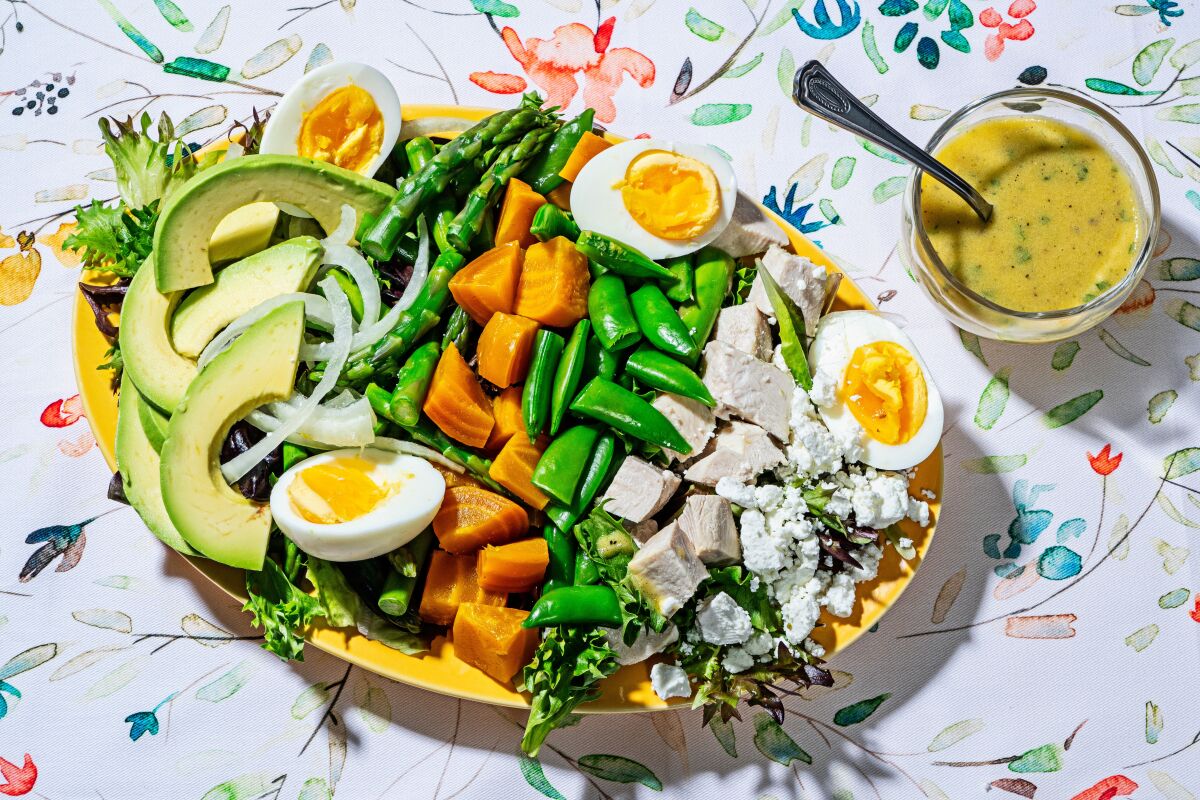 A Cobb salad with spring vegetables, cooked beets and chicken.