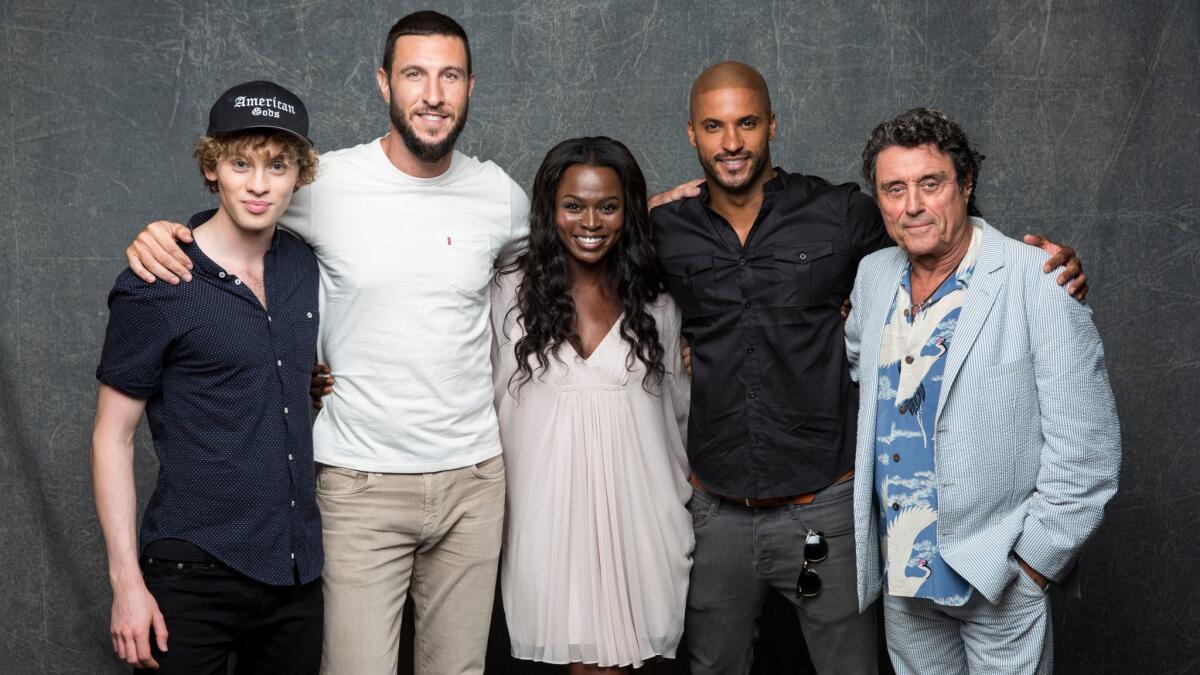 Bruce Langley (who plays Technical Boy), Pablo Schreiber (Mad Sweeney), Yetide Badaki (Bilquis), Ricky Whittle (Shadow Moon) and Ian McShane (Mr. Wednesday) of "American Gods" at the Hero Complex photo studio at San Diego Comic-Con 2016.