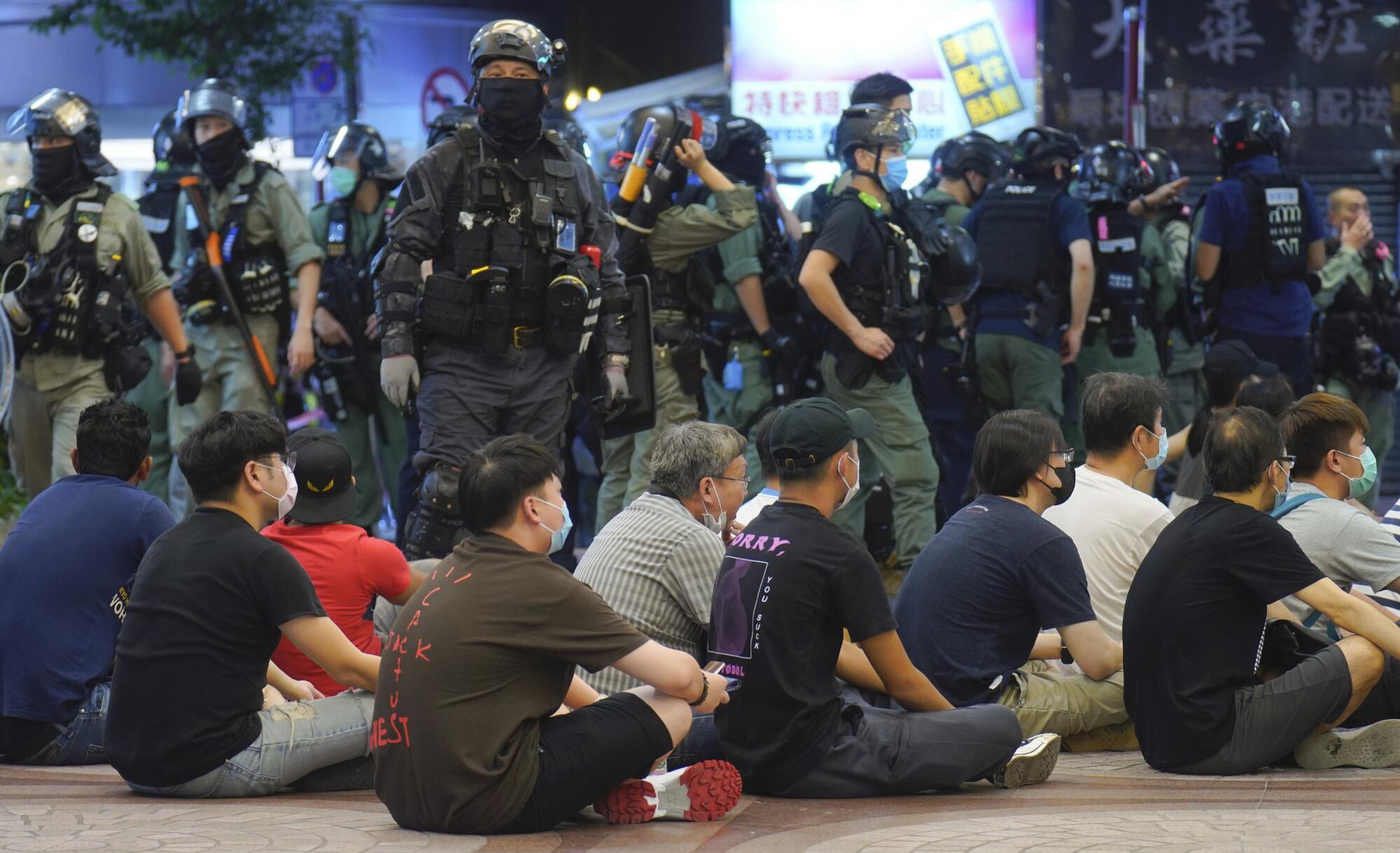 Police detain protesters against the new security law during a march marking the anniversary of the Hong Kong