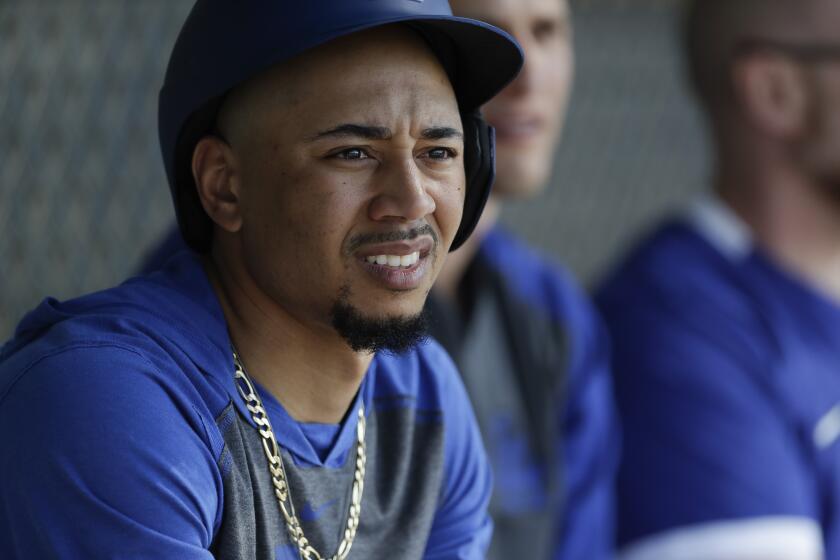 Los Angeles Dodgers right fielder Mookie Betts looks on during spring training baseball.