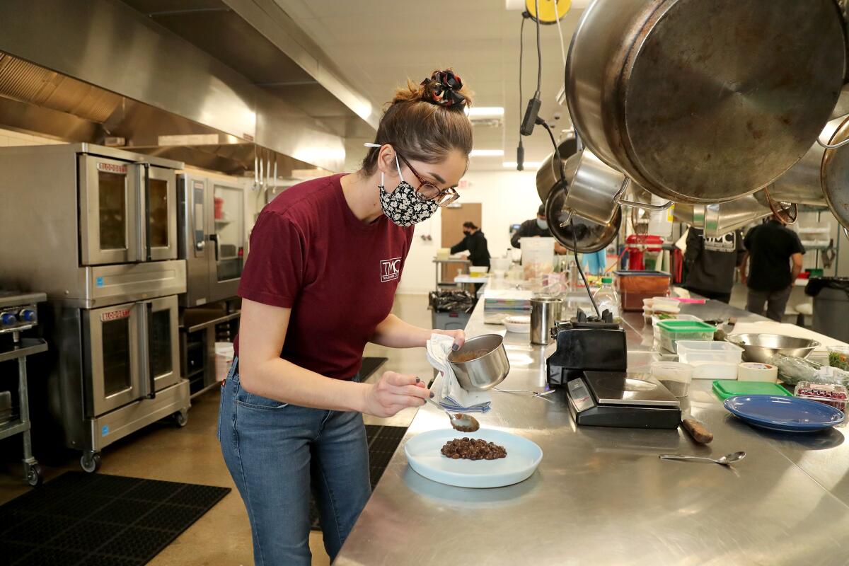 Liana Bates lays out cooked black beans at Taylor Made Cuisine.