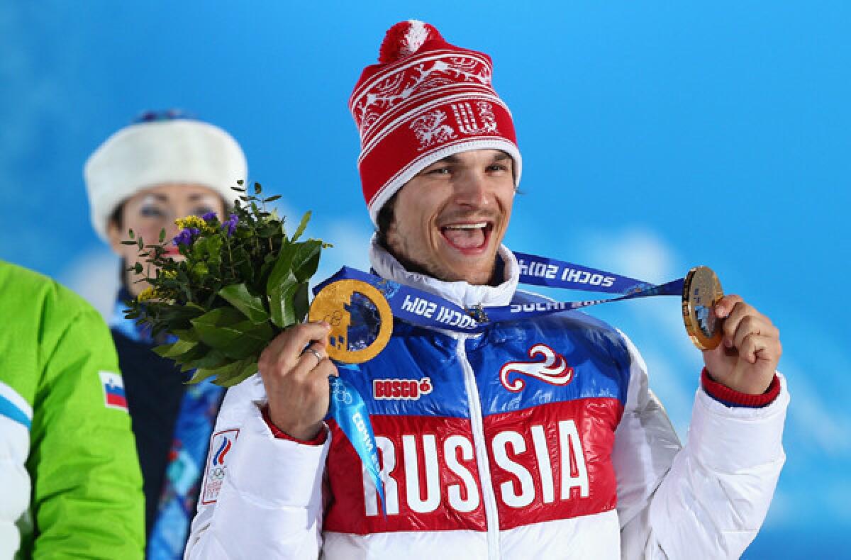 Vic Wild shows off his two gold medals on Saturday after winning the snowboarding parallel slalom. He won the giant parallel slalom on Wednesday.