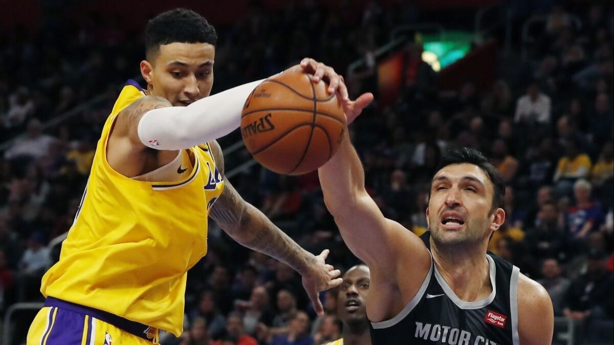 Lakers forward Kyle Kuzma, challenging Pistons center Zaza Pachulia for a rebound, wants to show he's more than just a scorer.