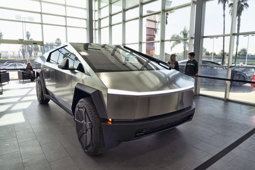 FILE - A Tesla Cybertruck is on display at the Tesla showroom in Buena Park, Calif., Dec. 3, 2023. Tesla is recalling its futuristic new Cybertruck pickup for the fourth time in the U.S. to fix problems with trim pieces that can come loose and front windshield wipers that can fail. The new recalls, announced in documents posted Tuesday, June 25, 2024, by the National Highway Traffic Safety Administration, each affect more than 11,000 trucks. (AP Photo/Richard Vogel, File)