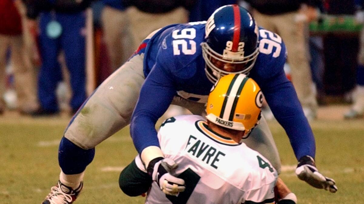Giants defensive end Michael Strahan (92) sacks Packers quarterback Brett Favre during the fourth quarter on Jan. 6, 2002, at Giants Stadium in East Rutherford, N.J. The sack gave Strahan 22.5 sacks for the season surpassing Jets' Mark Gastineau's record of 22 sacks.