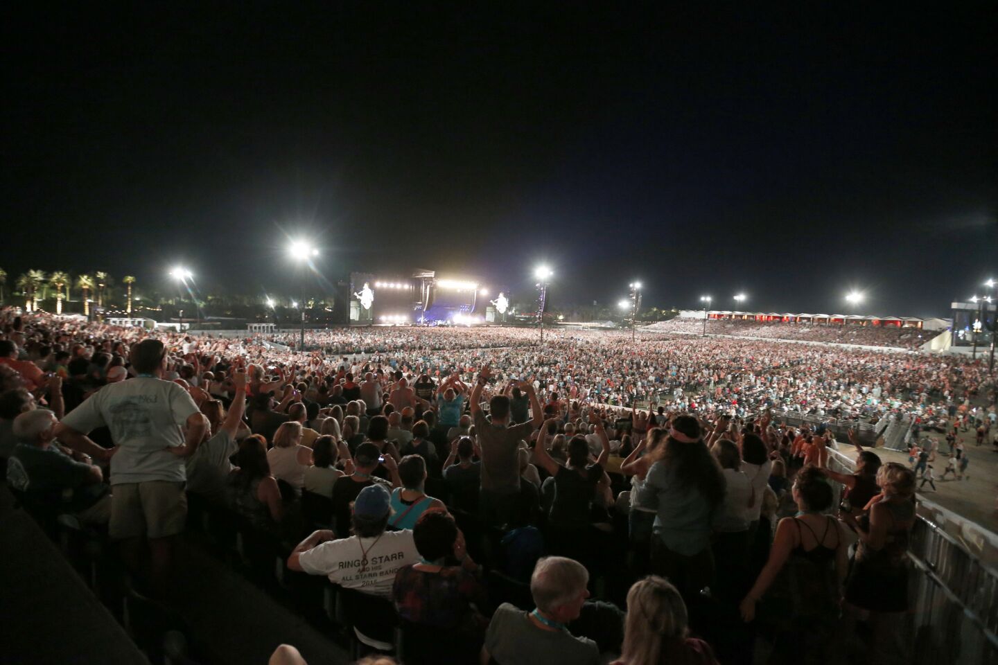 A view from the grandstand seats as fans cheer and sing along to Paul McCartney's performance on the second day of the three-day Desert Trip at the Empire Polo Club grounds in Indio.