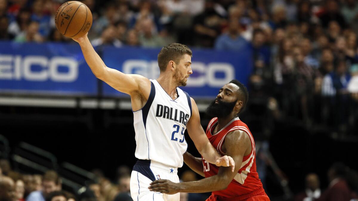 Dallas Mavericks forward Chandler Parsons protects the ball against the defense of Houston Rockets guard James Harden during a game on April 2.