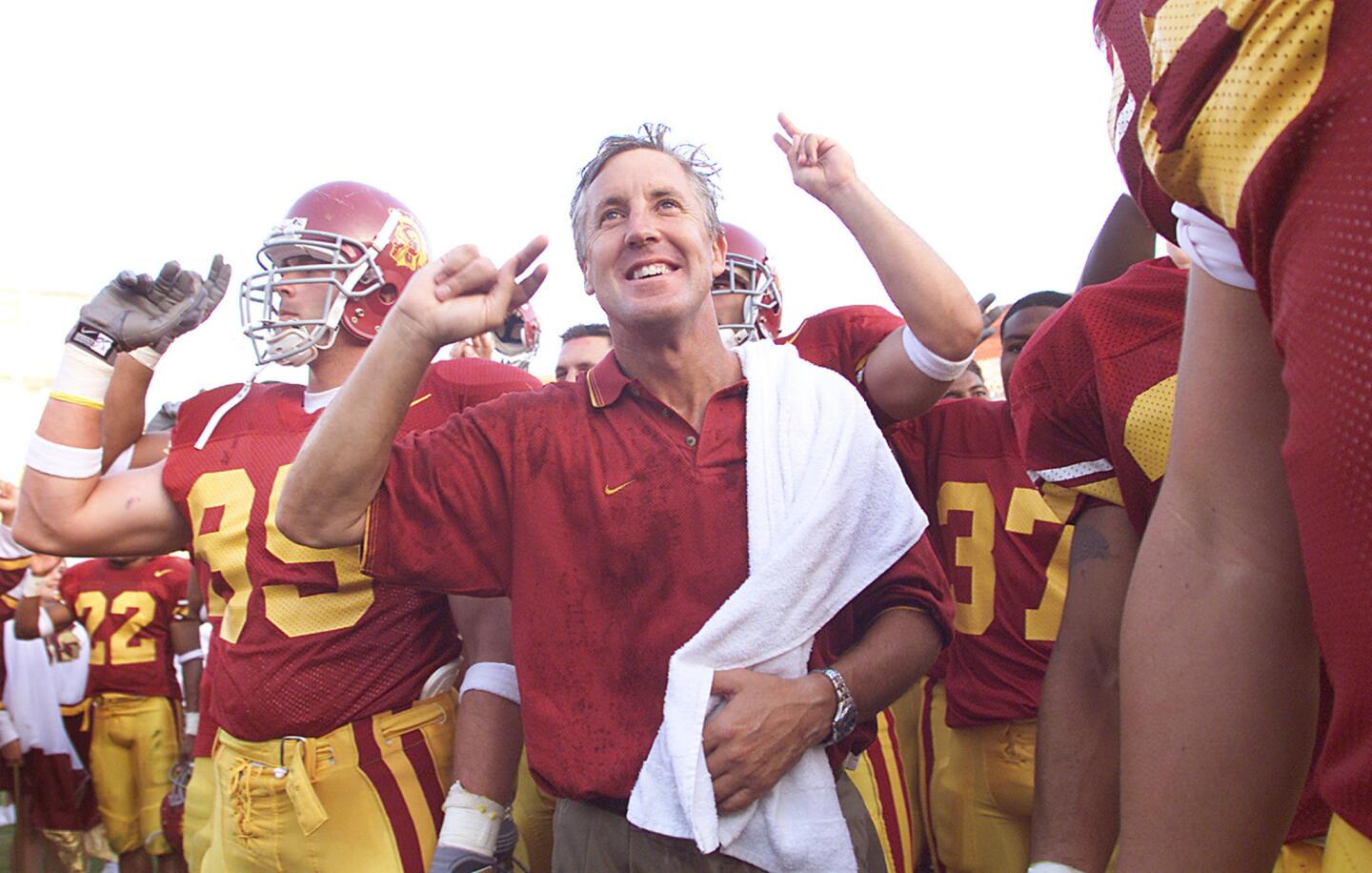 Pete Carroll sings the USC fight song with his players after the Trojans beat San Jose State on Sept. 1, 2001, his first game at the Los Angeles Memorial Coliseum.