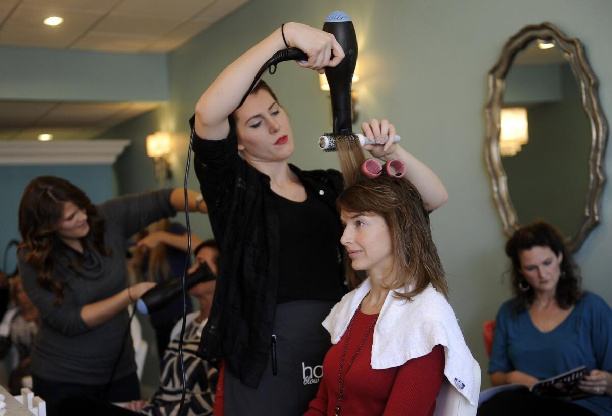 In a ranking of least-stressful jobs by CareerCast.com, hair stylists ranked No. 2. Above, a stylist blow-dries a client's hair in November at a Towson, Md., salon.