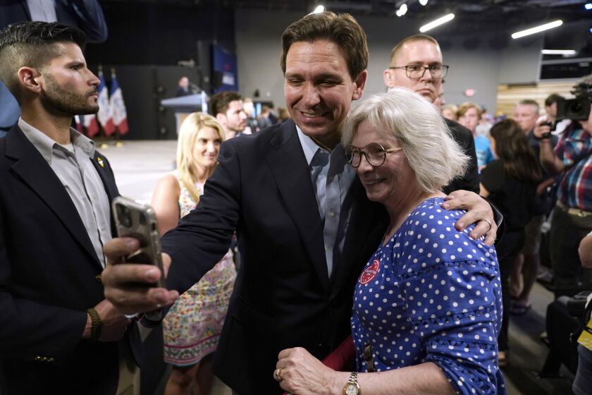 FILE - Republican presidential candidate Florida Gov. Ron DeSantis poses for a photo with Bette Guzman, of West Des Moines, Iowa, during a campaign event, May 30, 2023, in Clive, Iowa. As DeSantis embarked on the first official week of his presidential candidacy, the Florida governor repeatedly hit his chief rival, Donald Trump, from the right.(AP Photo/Charlie Neibergall, File)