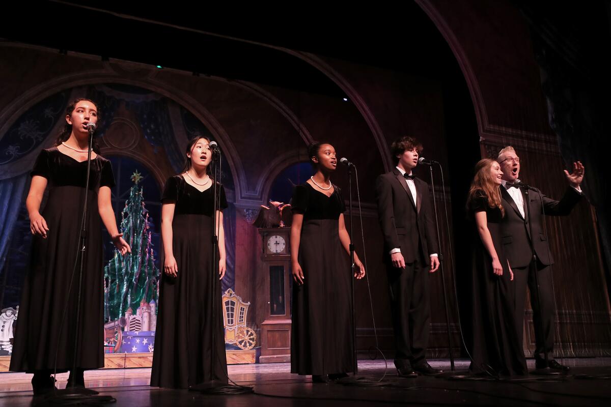 University High School choir members sing holiday carols at the Irvine Barclay Theatre.