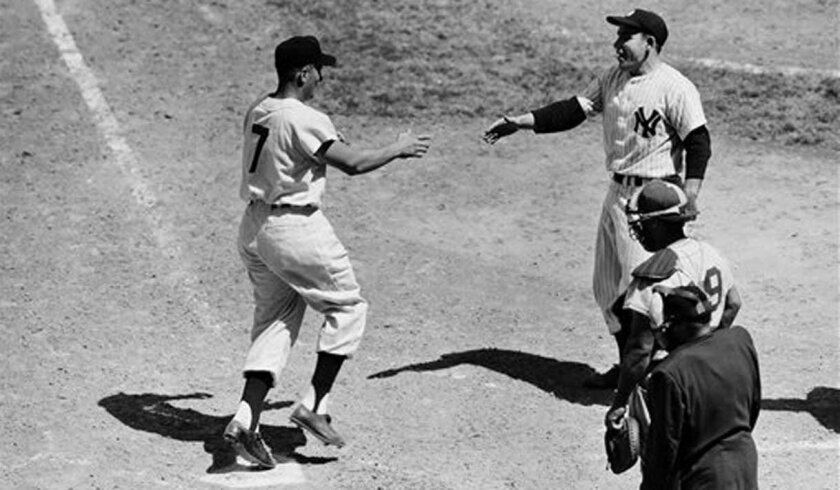Cleveland's Al Rosen is greeted at home plate by the Yankees' Yogi Berra after Rosen hit his second home run for the AL in the 1954 All-Star Game.