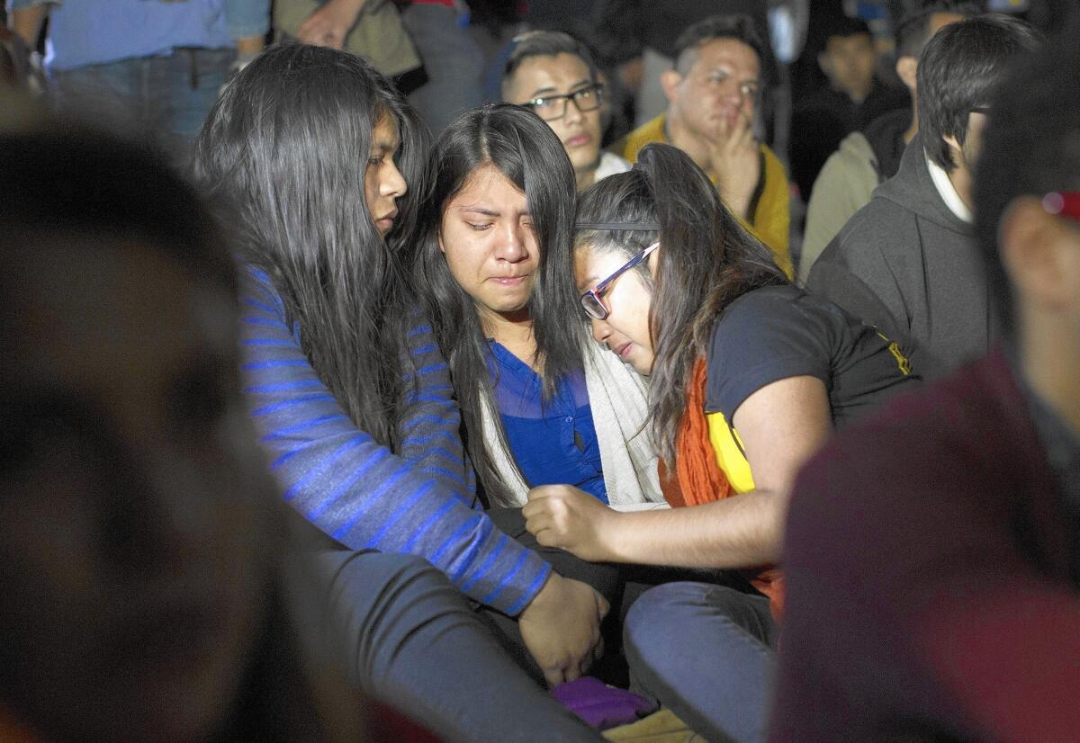 Miriam Lopez, left, Faby Jacome and Dulce Saavedra are brought to tears as they watch President Obama's immigration address. His executive action created a pathway of opportunity for millions -- as well as a new opening for scam artists.