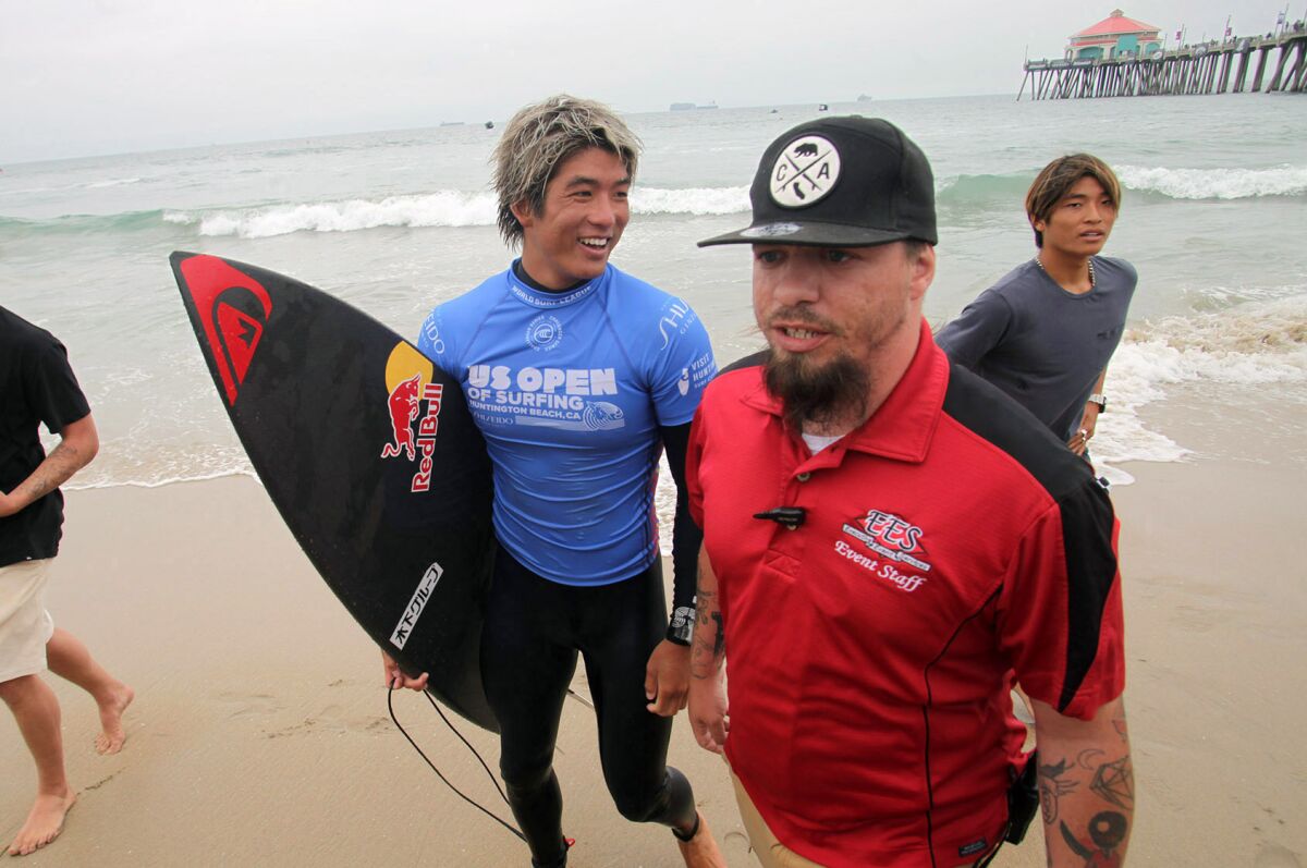 Kanoa Igarashi of Huntington Beach walks off the beach after his semifinal heat during the 2021 U.S. Open of Surfing.