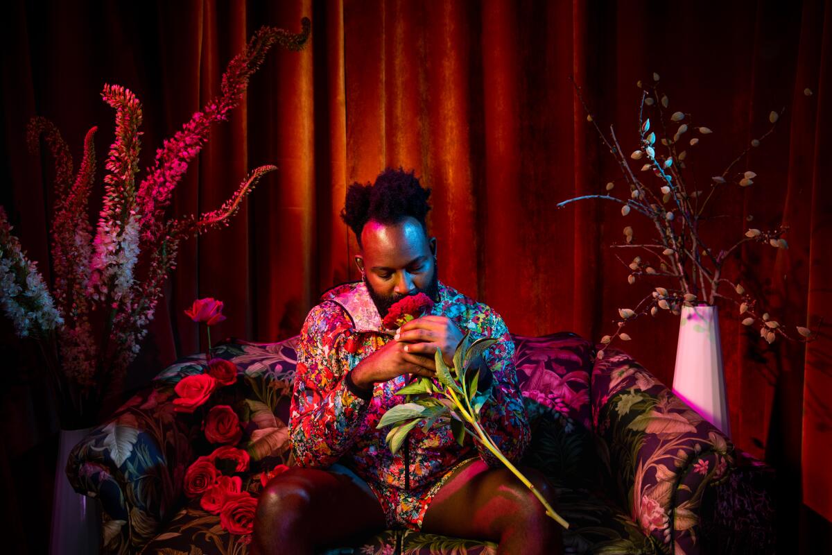 Floral artist Maurice Harris sniffs a bloom in his Los Angeles storefront.