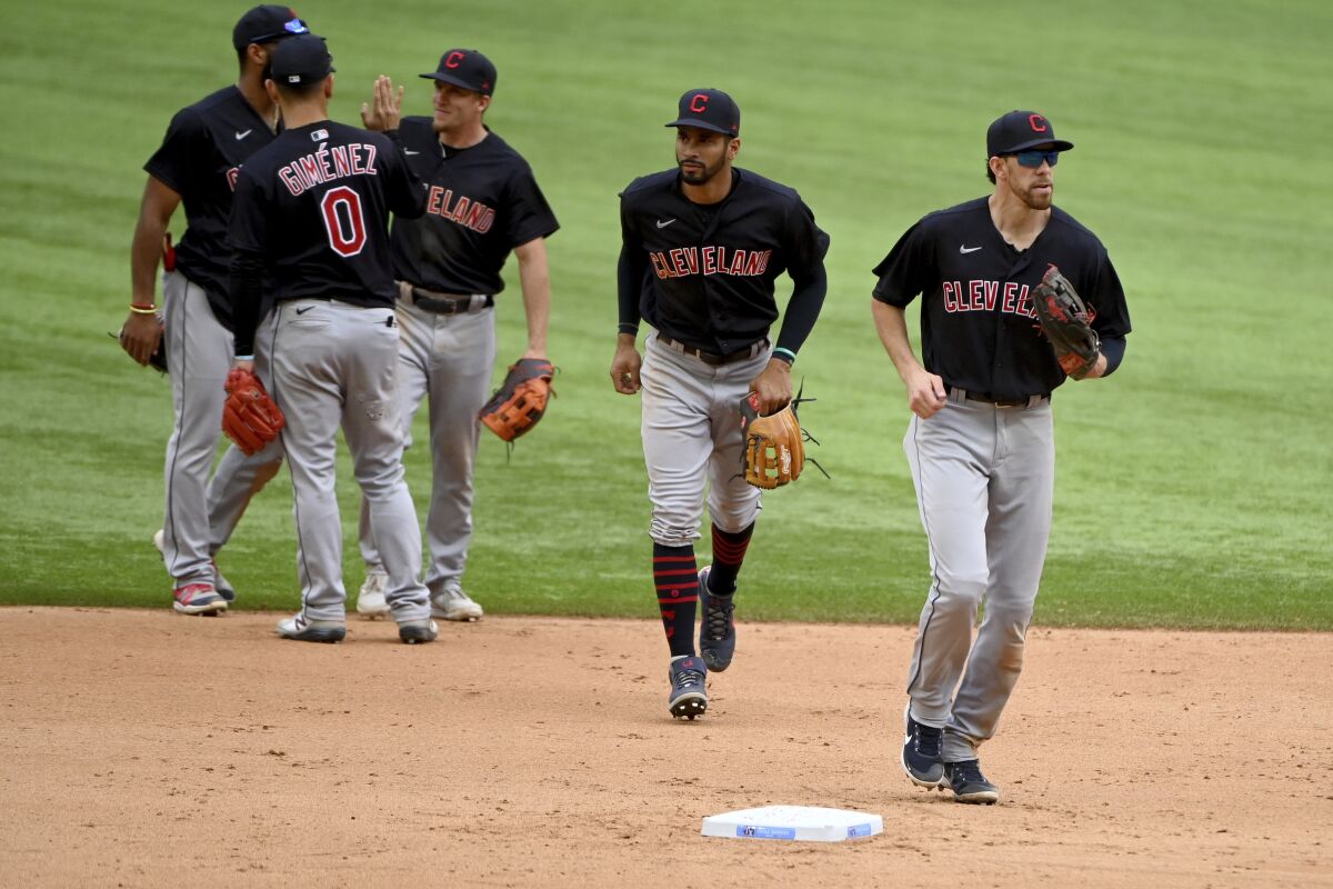 Cleveland Indians players, led by Bradley Zimmer, right, leave the field after their win over the Texas Rangers in a baseball game in Arlington Texas, Sunday, Oct. 3, 2021. (AP Photo/Matt Strasen)