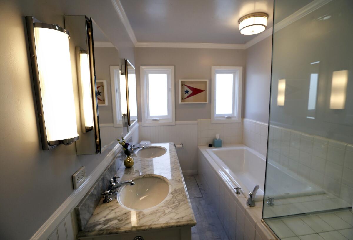 The main bathroom features a new vanity with carrera marble countertop and floor. (Mel Melcon / Los Angeles Times)
