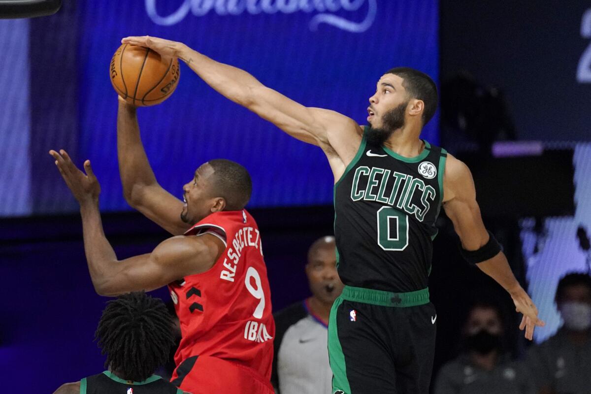 Boston Celtics' Jayson Tatum blocks the shot of Toronto Raptors' Serge Ibaka.