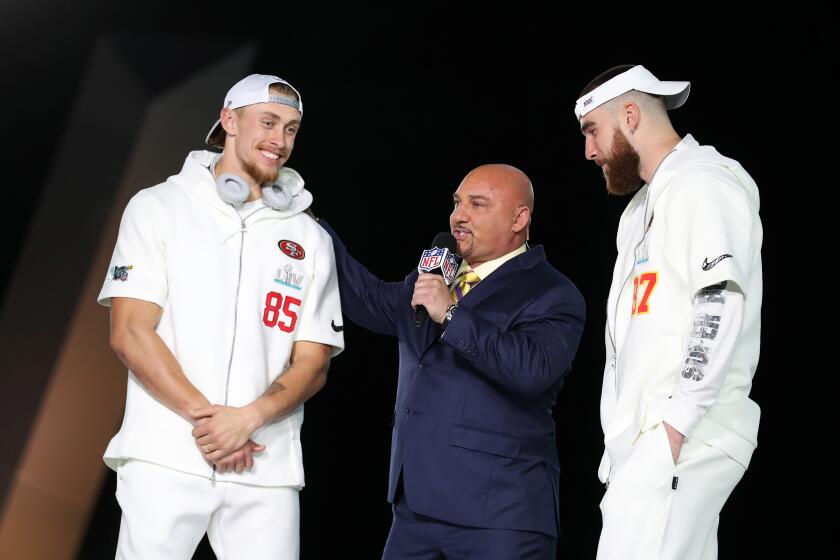 MIAMI, FLORIDA - JANUARY 27: Tight end George Kittle #85 of the San Francisco 49ers and tight end Travis Kelce #87 of the Kansas City Chiefs speak to sportscaster Jay Glazer during Super Bowl Opening Night presented by BOLT24 at Marlins Park on January 27, 2020 in Miami, Florida. (Photo by Michael Reaves/Getty Images)