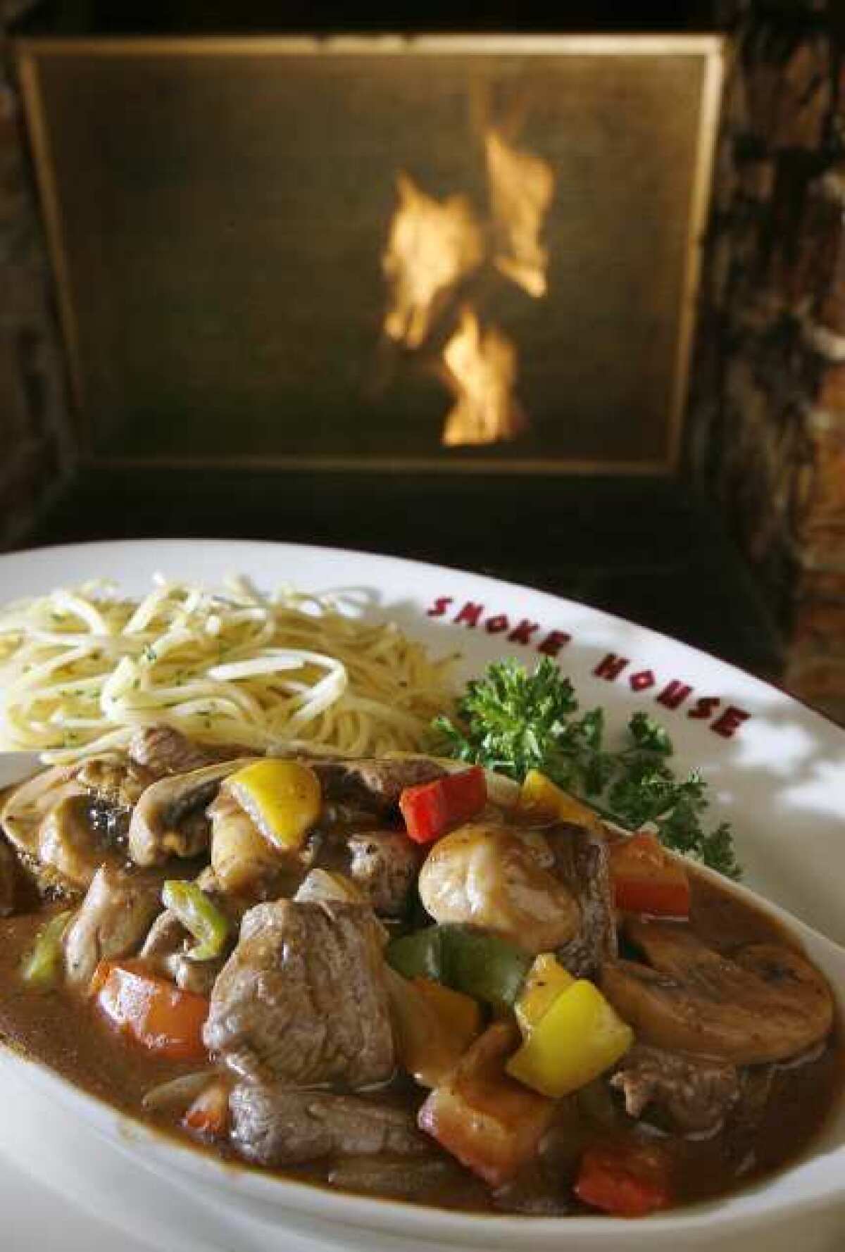 Steak Sinatra, of tenderloin chunks in a stew-like broth with mushrooms and vegetables, served with pasta at SmokeHouse in Burbank.