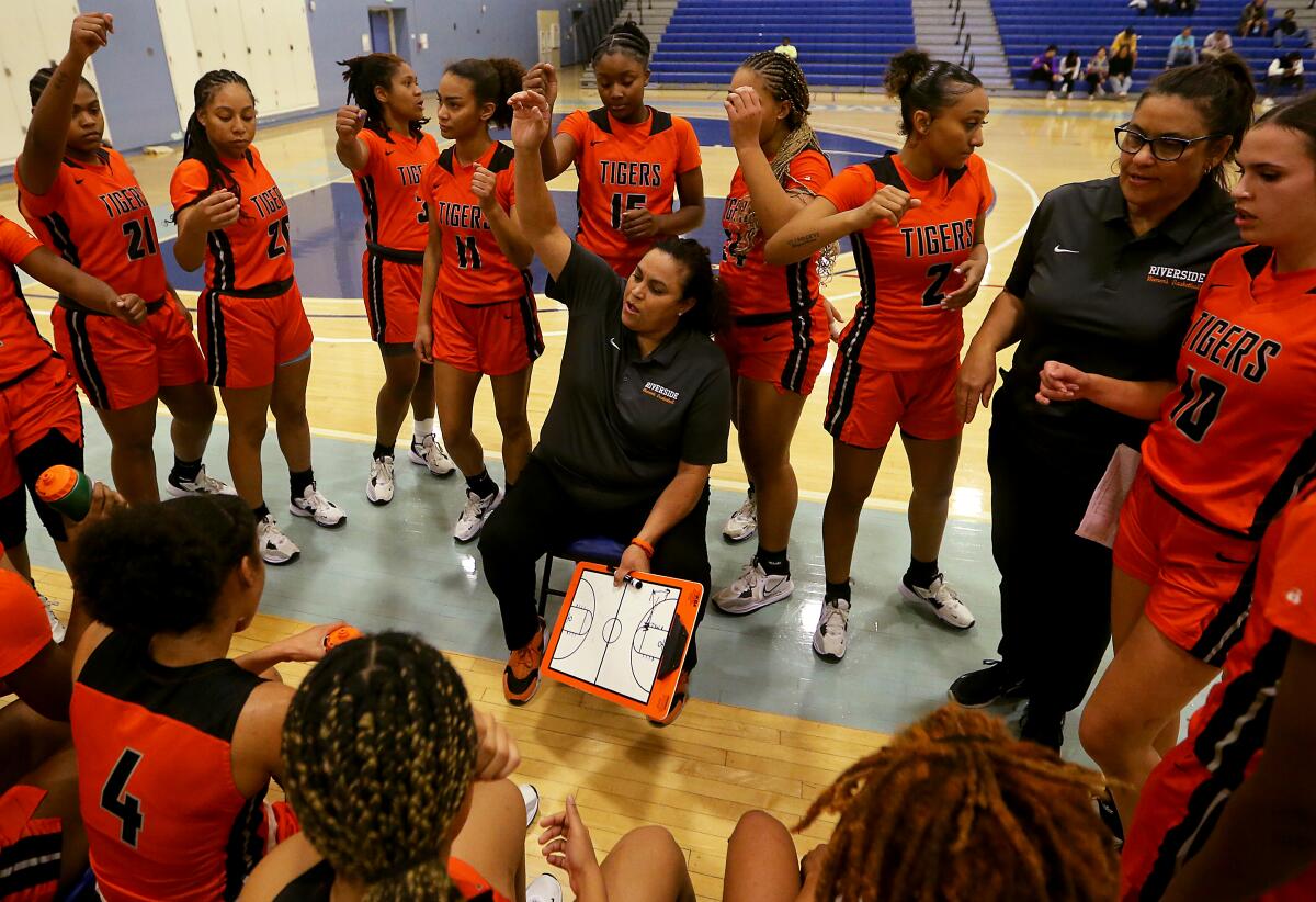 Riverside City College women's basketball coach Alicia Berber huddles with her team.