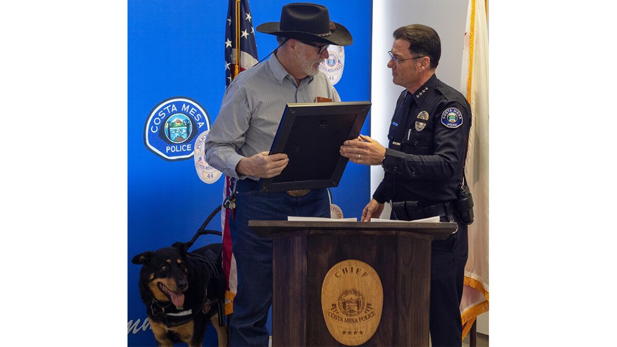 Charlie Lush receives the Distinguished Citizen Award from Chief Ron Lawrence.