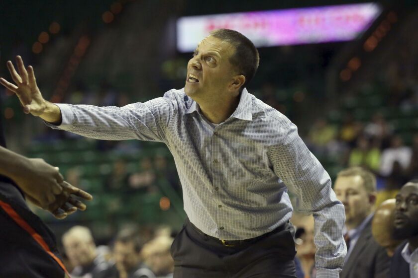 FILE - Sam Houston State head coach Jason Hooten yells from the sidelines during the first half of an NCAA college basketball against Baylor game in Waco, Texas, Monday, Dec. 4, 2017. New Mexico State has hired Hooten to try to restore the program that was shut down in the middle of this season after a player was involved in a fatal shooting and another accused teammates of hazing. (AP Photo/LM Otero, File)