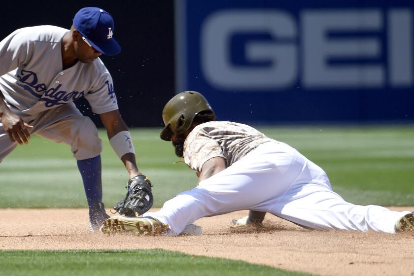 Dodgers shortstop Jimmy Rollins applies a late tag as Padres right fielder Matt Kemp steals second base in the fourth inning Sunday in San Diego.