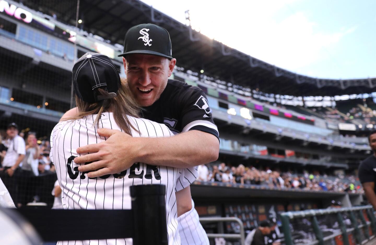 White Sox third baseman Todd Frazier gives a hug to a fan before game against the Los Angeles Dodgers at Guaranteed Rate Field on July 18, 2017. Frazier was traded to the New York Yankees after the game.