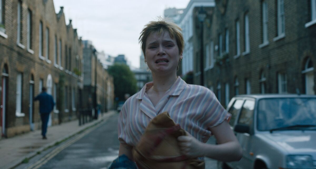 A woman walks down the street crying