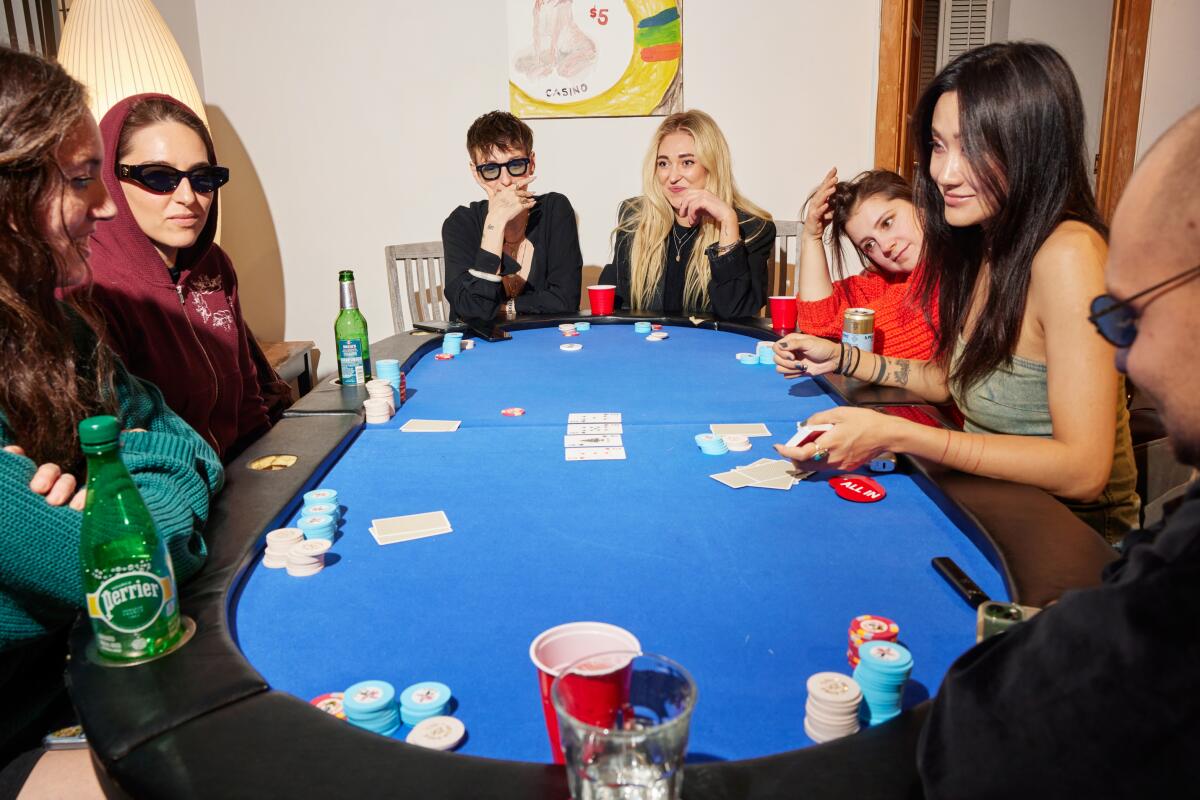 People sit at a poker table