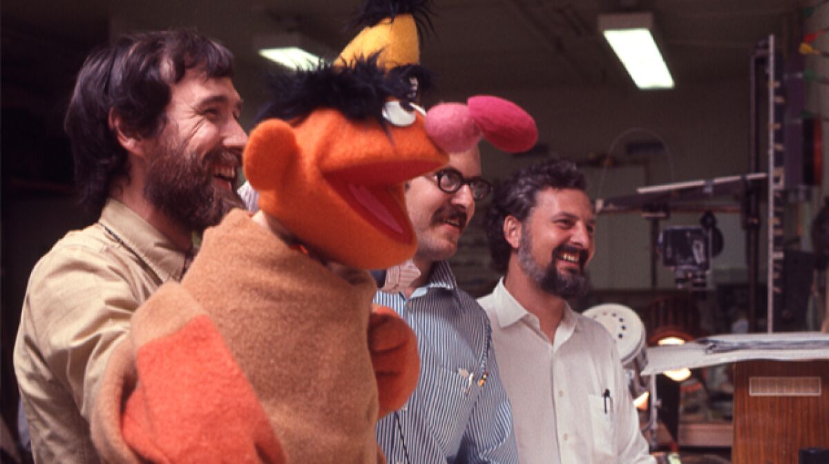 Puppeteers Jim Henson (left) and Frank Oz are shown with director/writer Jon Stone on the set of "Sesame Street." 