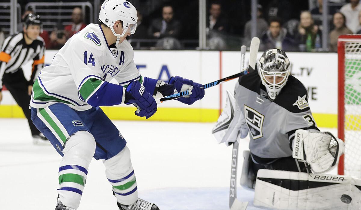 Vancouver Canucks' Alexandre Burrows, left, gets his shot stopped by Kings goalie Peter Budaj during the shootout on Saturday.