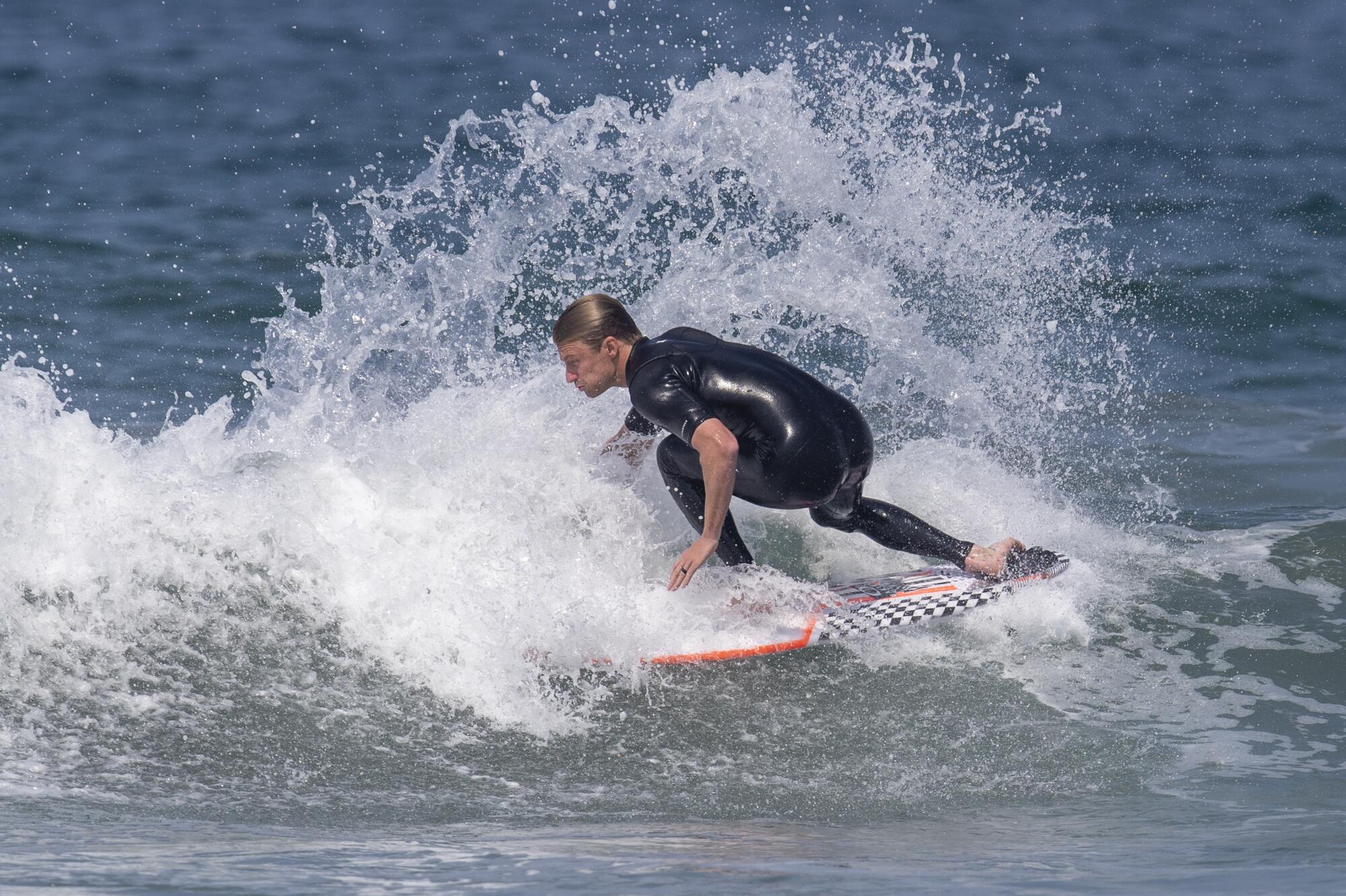 Kolohe Andino does a backside snap on a small wave at Bolsa Chica State Beach.