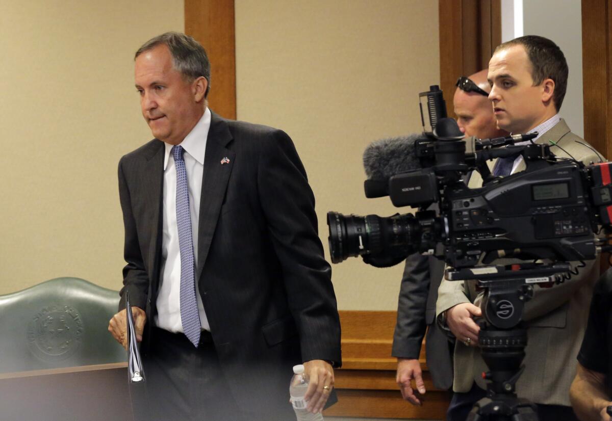 Texas Atty. Gen. Ken Paxton, left, seen here arriving at last week's Texas Senate Health and Human Services Committee hearing.